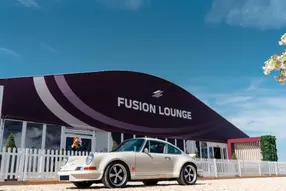 Admire a hand-picked selection of luxury vehicles and supercars, alongside interactive racing simulators